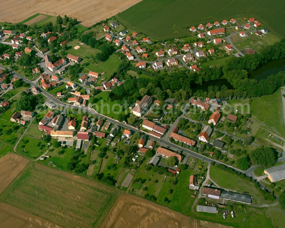 Aerial image Naunhof - Agricultural land and field boundaries surround the settlement area of the village in Naunhof in the state Saxony, Germany