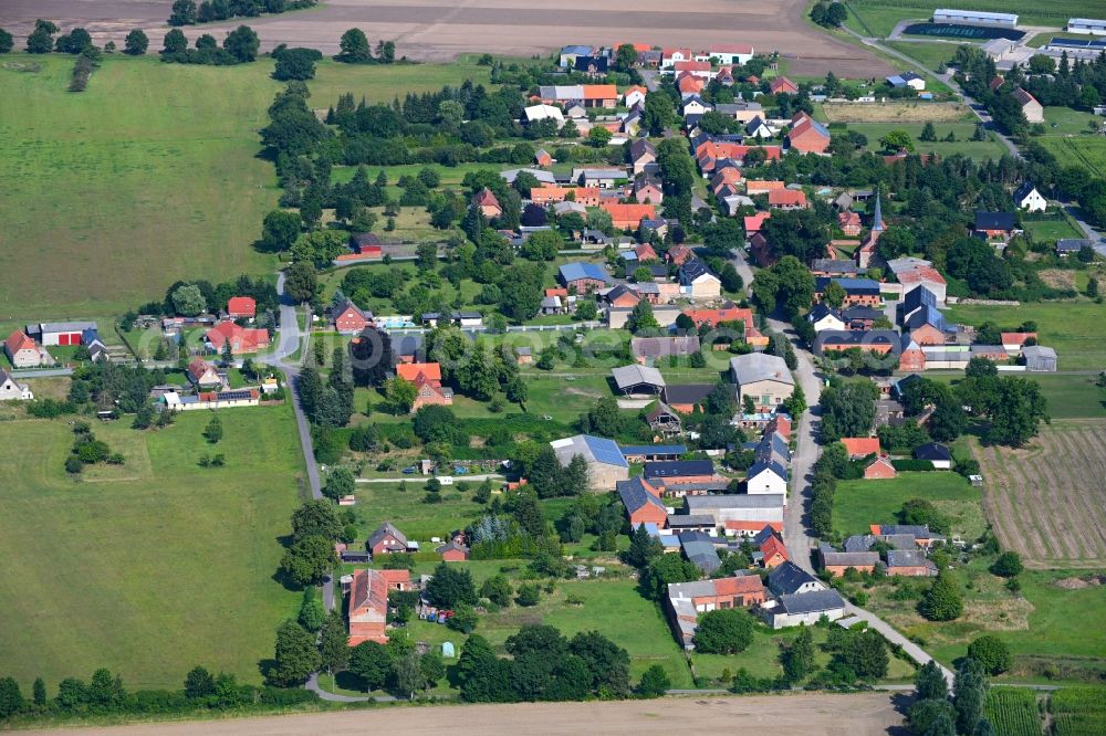 Nebelin from the bird's eye view: Agricultural land and field boundaries surround the settlement area of the village in Nebelin in the state Brandenburg, Germany