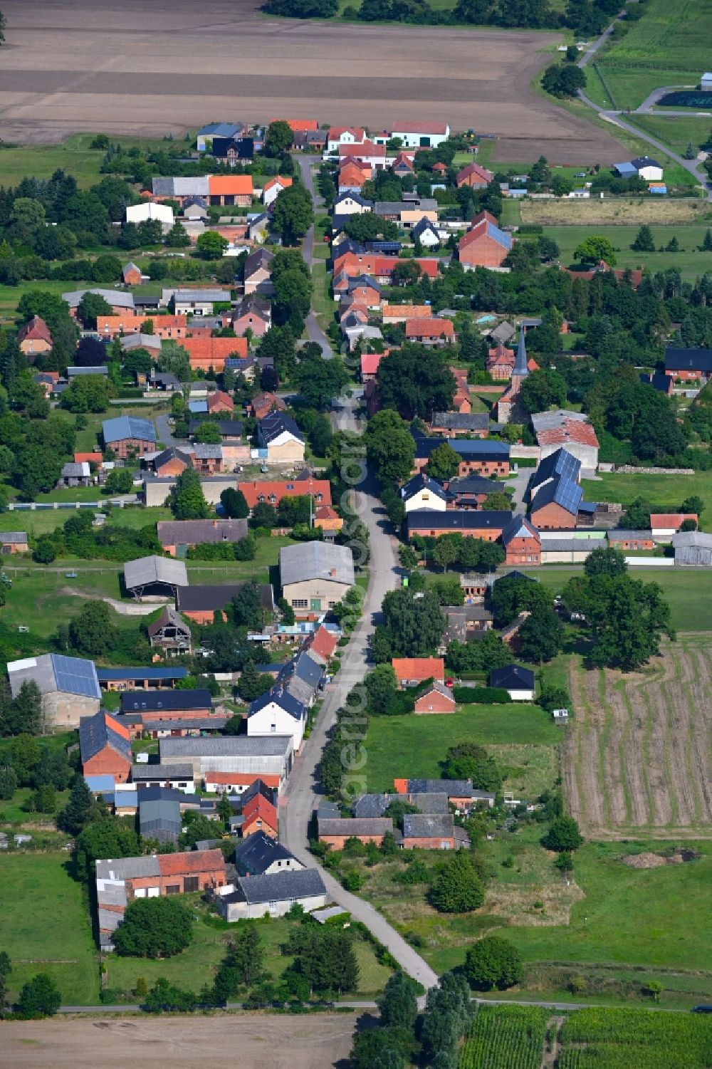 Aerial image Nebelin - Agricultural land and field boundaries surround the settlement area of the village in Nebelin in the state Brandenburg, Germany