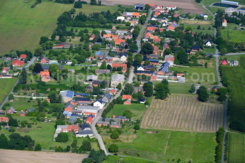 Nebelin from above - Agricultural land and field boundaries surround the settlement area of the village in Nebelin in the state Brandenburg, Germany