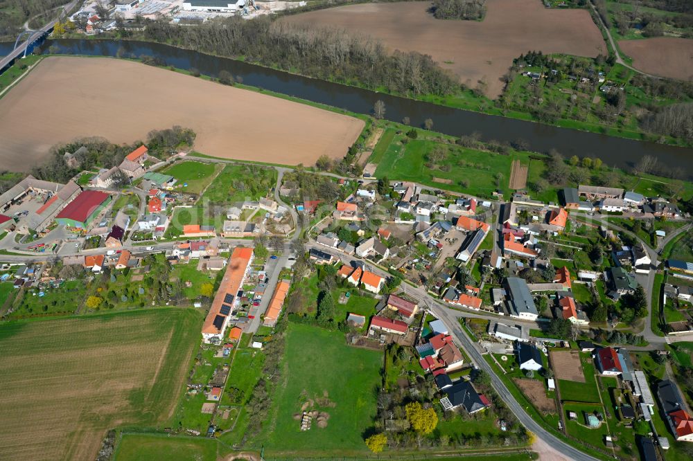 Nelben from the bird's eye view: Agricultural land and field boundaries surround the settlement area of the village in Nelben in the state Saxony-Anhalt, Germany