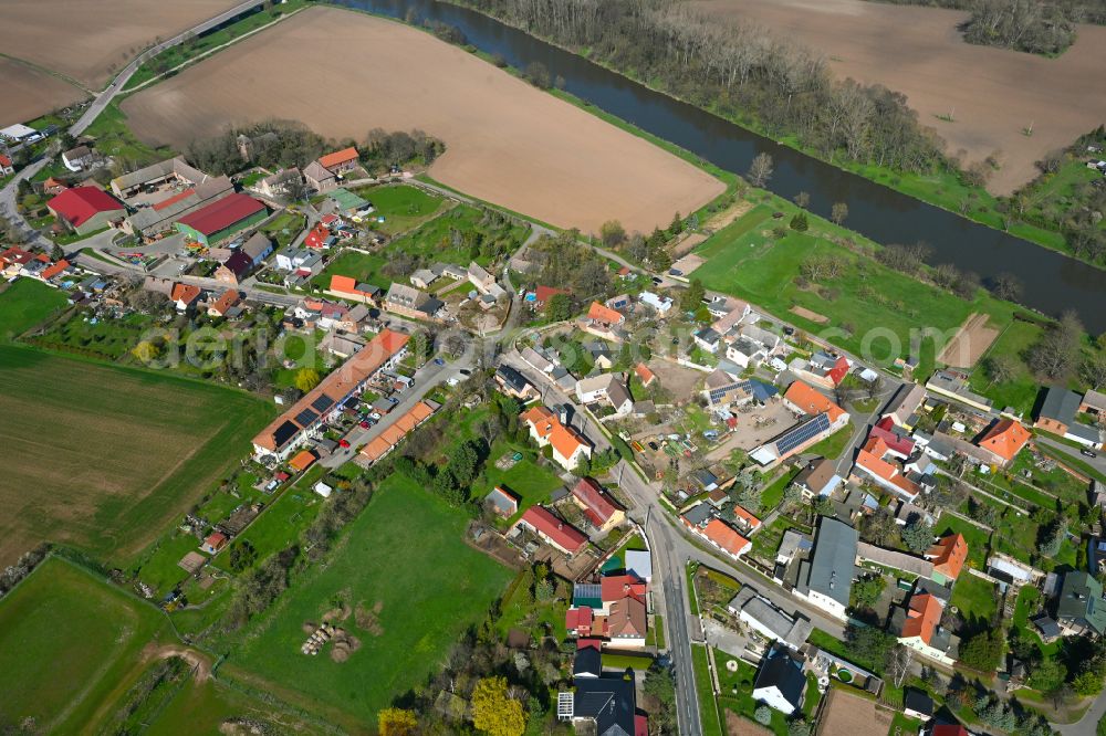 Nelben from the bird's eye view: Agricultural land and field boundaries surround the settlement area of the village in Nelben in the state Saxony-Anhalt, Germany