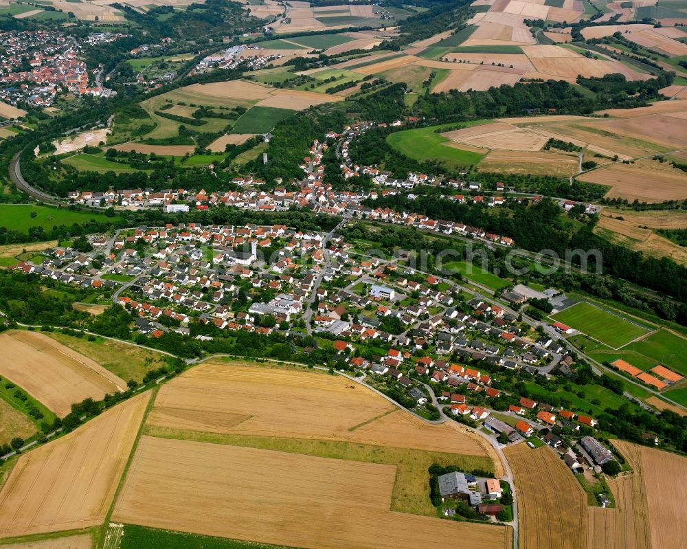 Neudenau from above - Agricultural land and field boundaries surround the settlement area of the village in Neudenau in the state Baden-Wuerttemberg, Germany