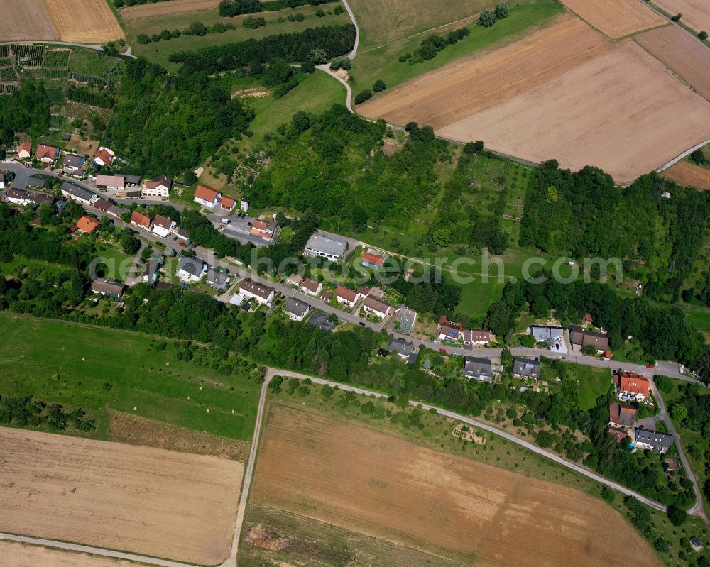 Neudenau from the bird's eye view: Agricultural land and field boundaries surround the settlement area of the village in Neudenau in the state Baden-Wuerttemberg, Germany