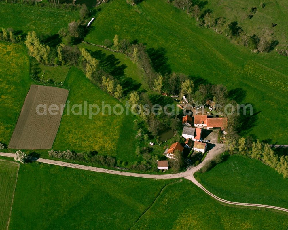 Neudorf from above - Agricultural land and field boundaries surround the settlement area of the village in Neudorf in the state Bavaria, Germany