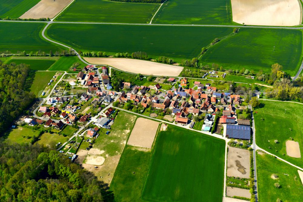 Neudorf from the bird's eye view: Agricultural land and field boundaries surround the settlement area of the village in Neudorf in the state Bavaria, Germany