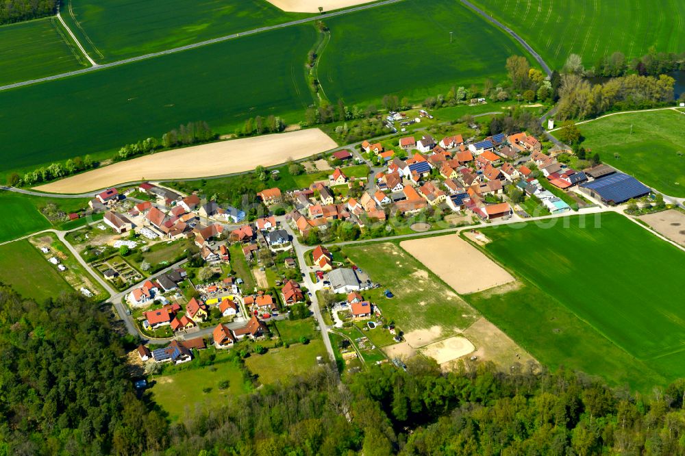 Aerial image Neudorf - Agricultural land and field boundaries surround the settlement area of the village in Neudorf in the state Bavaria, Germany