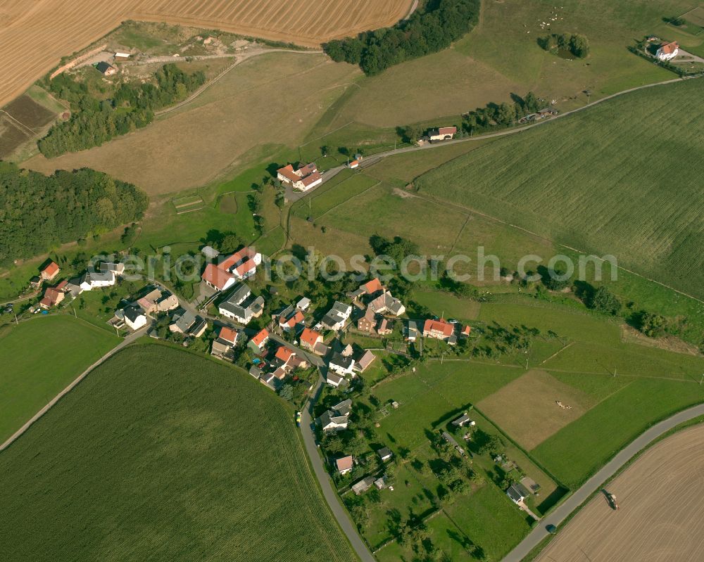 Neudörfel from above - Agricultural land and field boundaries surround the settlement area of the village in Neudörfel in the state Thuringia, Germany