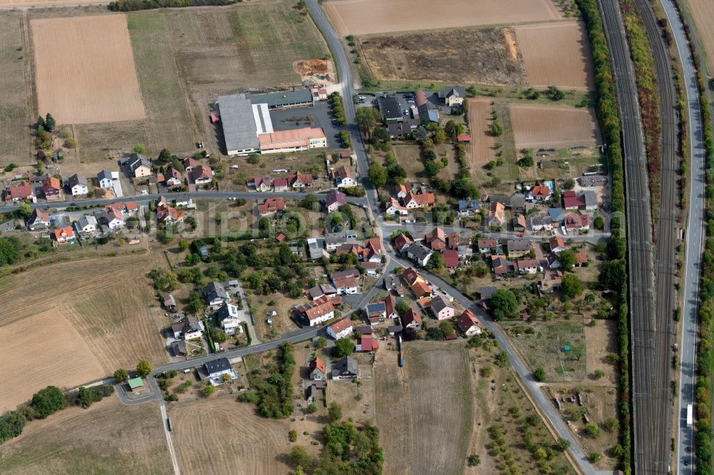 Aerial image Neuendorf - Agricultural land and field boundaries surround the settlement area of the village in Neuendorf in the state Bavaria, Germany