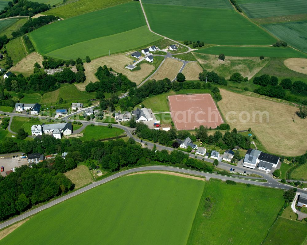 Neuerkirch from above - Agricultural land and field boundaries surround the settlement area of the village in Neuerkirch in the state Rhineland-Palatinate, Germany