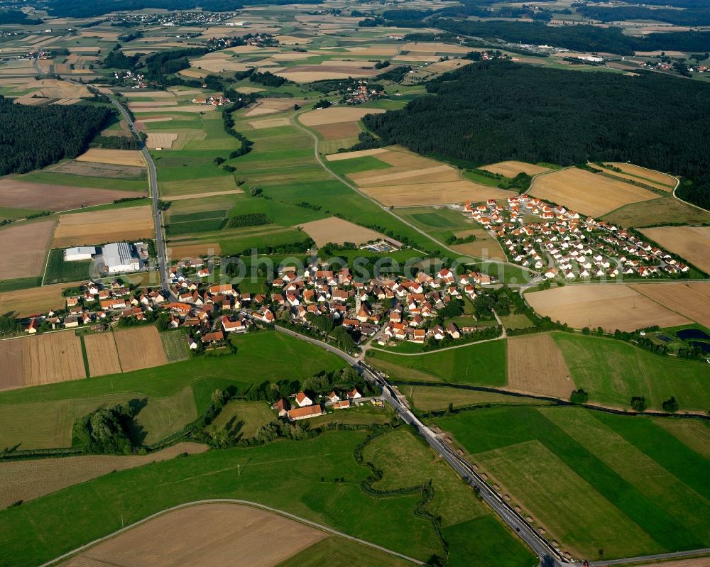 Neunstetten from the bird's eye view: Agricultural land and field boundaries surround the settlement area of the village in Neunstetten in the state Bavaria, Germany