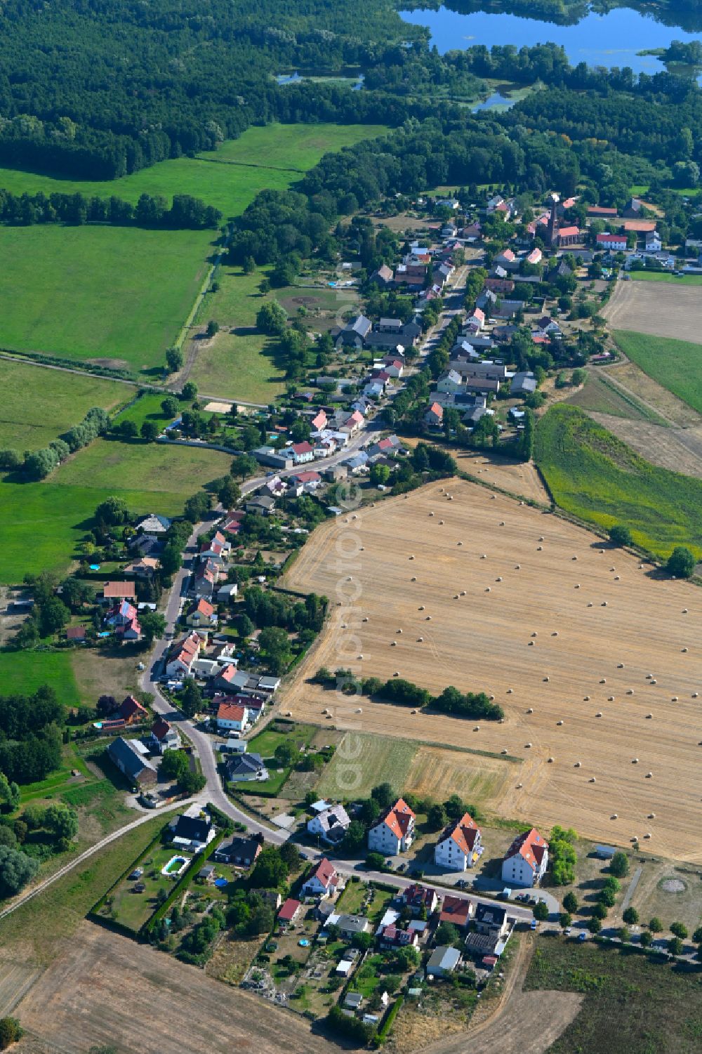 Aerial image Neuschmerzke - Agricultural land and field boundaries surround the settlement area of the village in Neuschmerzke in the state Brandenburg, Germany