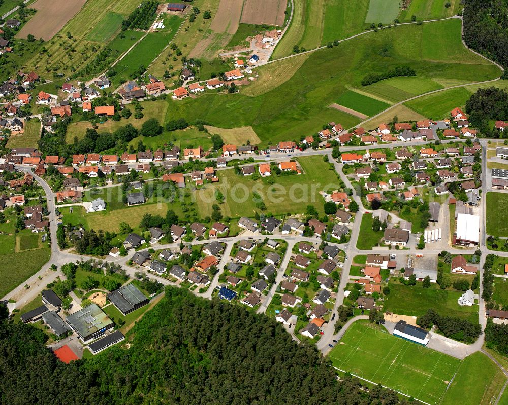 Neuweiler from above - Agricultural land and field boundaries surround the settlement area of the village in Neuweiler in the state Baden-Wuerttemberg, Germany