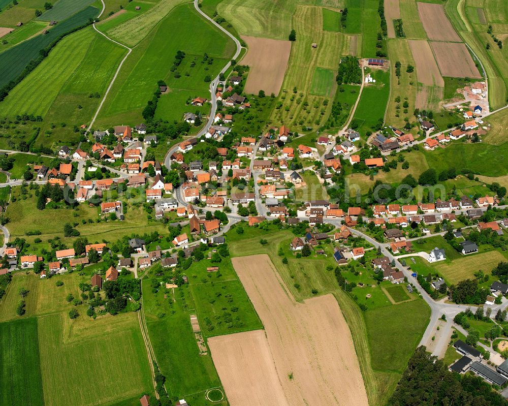 Neuweiler from the bird's eye view: Agricultural land and field boundaries surround the settlement area of the village in Neuweiler in the state Baden-Wuerttemberg, Germany