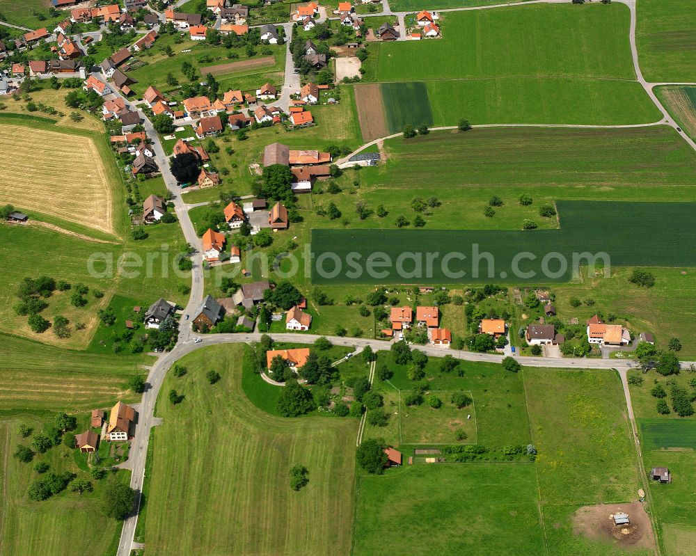 Aerial photograph Neuweiler - Agricultural land and field boundaries surround the settlement area of the village in Neuweiler in the state Baden-Wuerttemberg, Germany