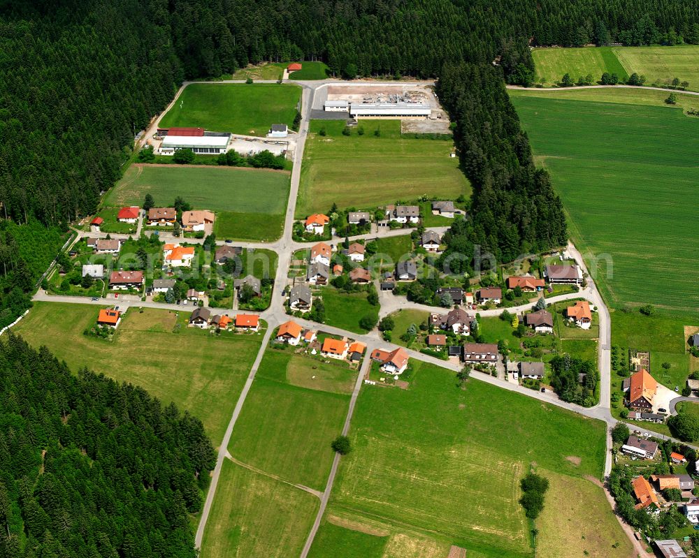 Neuweiler from above - Agricultural land and field boundaries surround the settlement area of the village in Neuweiler in the state Baden-Wuerttemberg, Germany