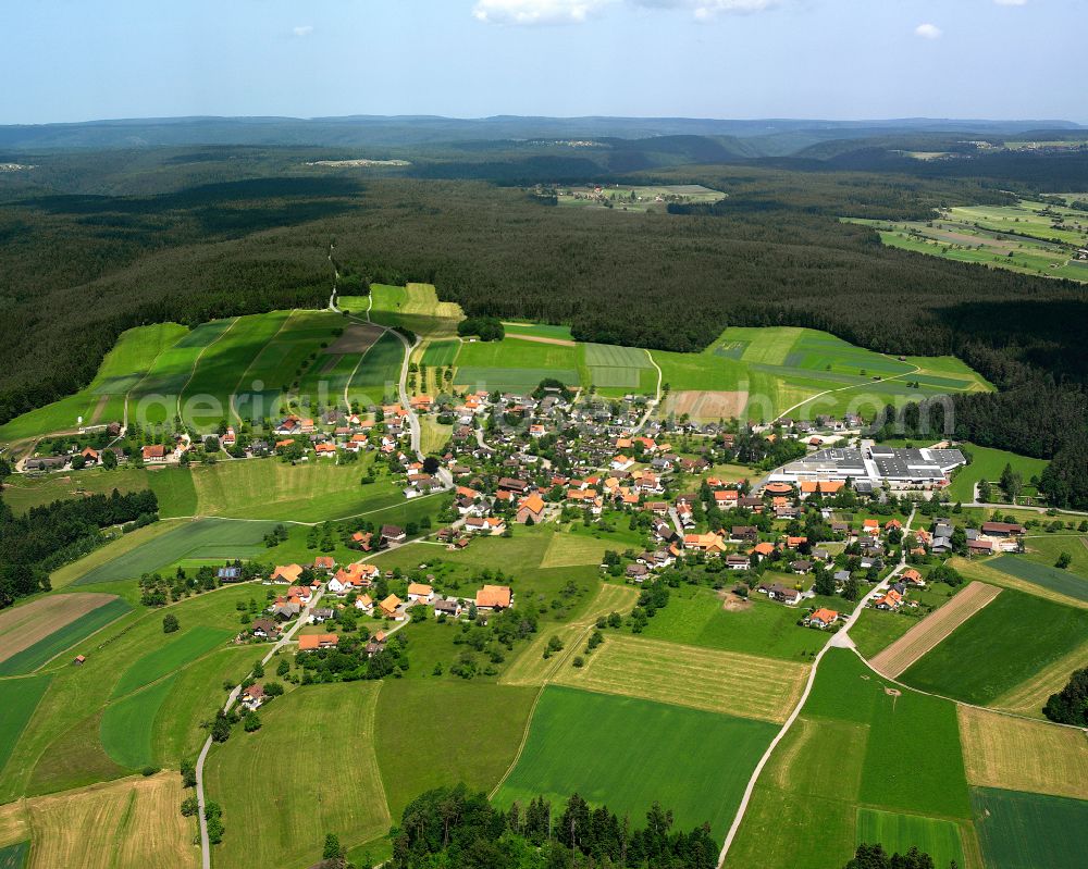 Neuweiler from above - Agricultural land and field boundaries surround the settlement area of the village in Neuweiler in the state Baden-Wuerttemberg, Germany