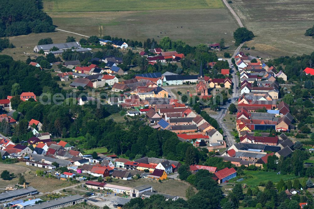 Aerial image Nichel - Agricultural land and field boundaries surround the settlement area of the village in Nichel in the state Brandenburg, Germany