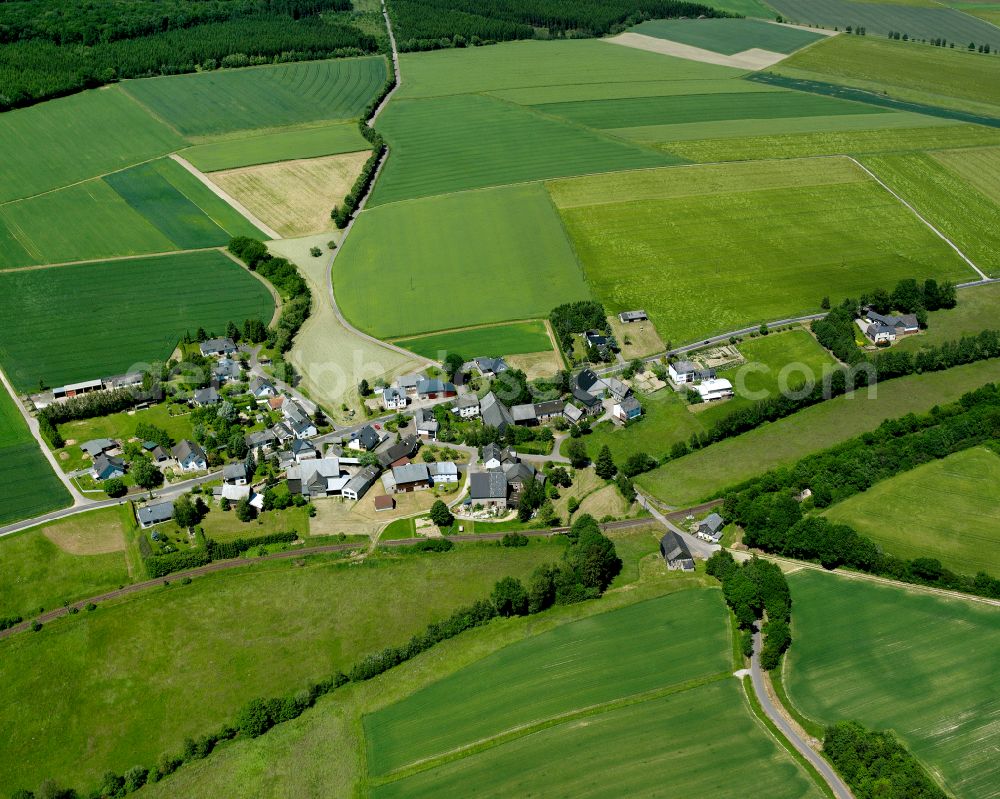 Aerial image Nickweiler - Agricultural land and field boundaries surround the settlement area of the village in Nickweiler in the state Rhineland-Palatinate, Germany