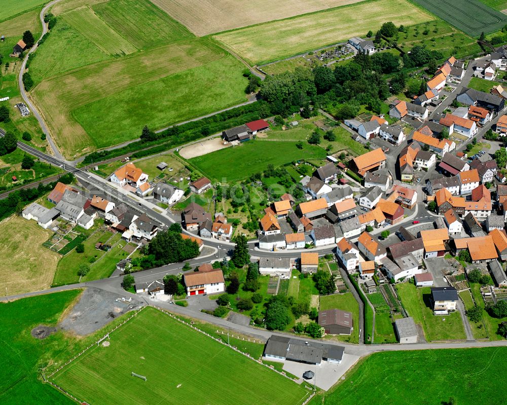 Aerial image Nieder-Gemünden - Agricultural land and field boundaries surround the settlement area of the village in Nieder-Gemünden in the state Hesse, Germany