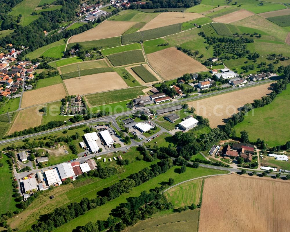 Aerial image Nieder-Kainsbach - Agricultural land and field boundaries surround the settlement area of the village in Nieder-Kainsbach in the state Hesse, Germany