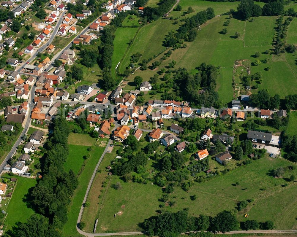 Nieder-Kinzig from the bird's eye view: Agricultural land and field boundaries surround the settlement area of the village in Nieder-Kinzig in the state Hesse, Germany