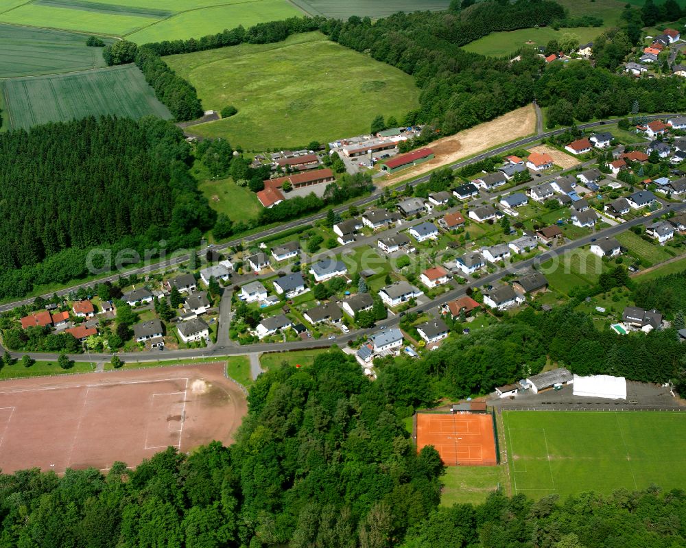 Nieder-Ohmen from above - Agricultural land and field boundaries surround the settlement area of the village in Nieder-Ohmen in the state Hesse, Germany