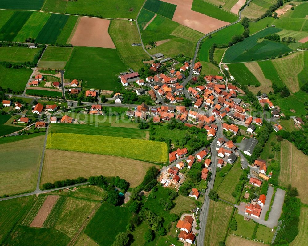 Niedergude from above - Agricultural land and field boundaries surround the settlement area of the village in Niedergude in the state Hesse, Germany