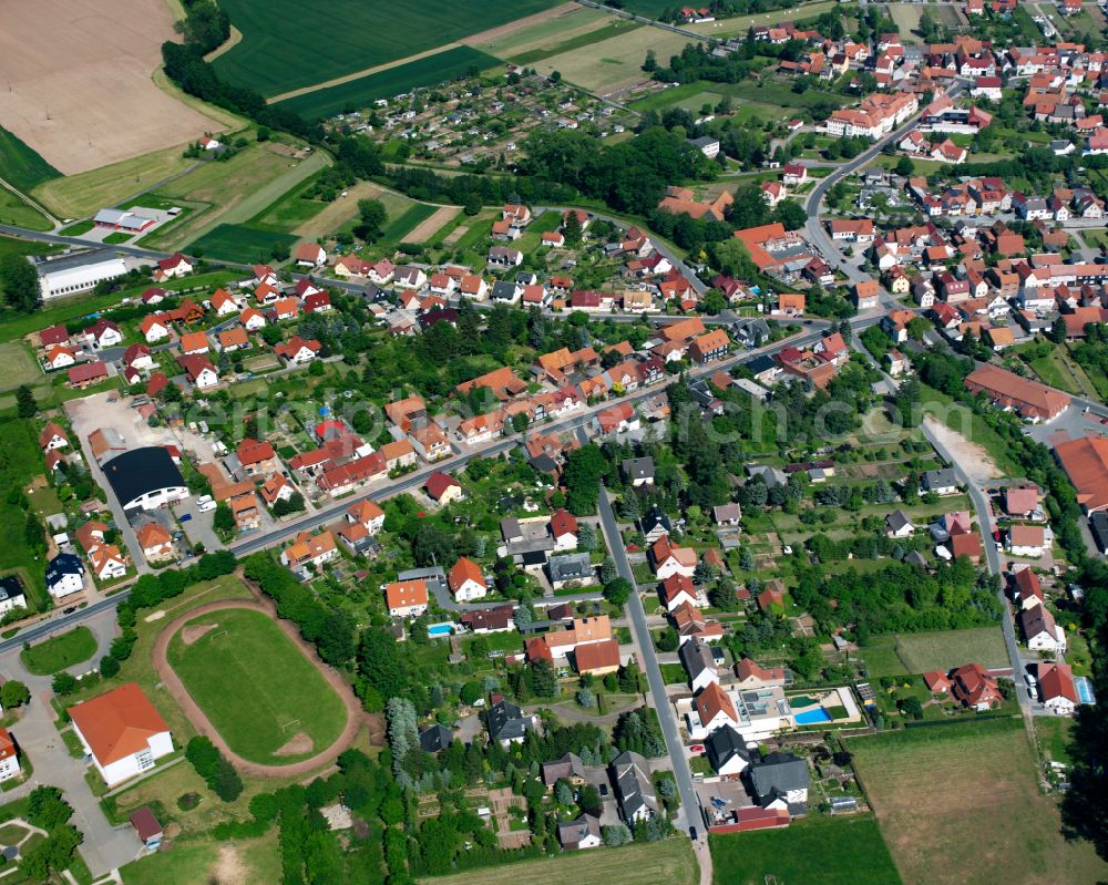 Niederorschel from the bird's eye view: Agricultural land and field boundaries surround the settlement area of the village in Niederorschel in the state Thuringia, Germany