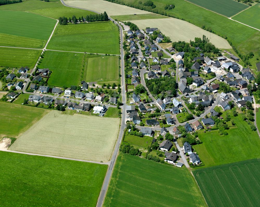 Niedersohren from above - Agricultural land and field boundaries surround the settlement area of the village in Niedersohren in the state Rhineland-Palatinate, Germany