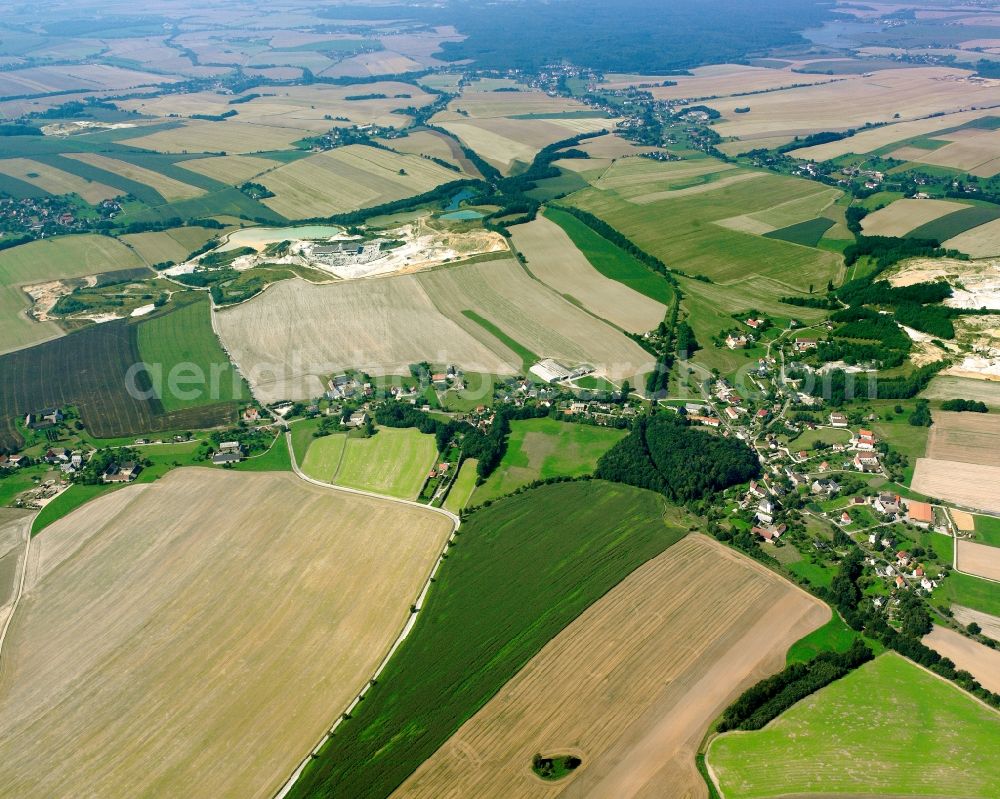 Niedersteinbach from above - Agricultural land and field boundaries surround the settlement area of the village in Niedersteinbach in the state Saxony, Germany