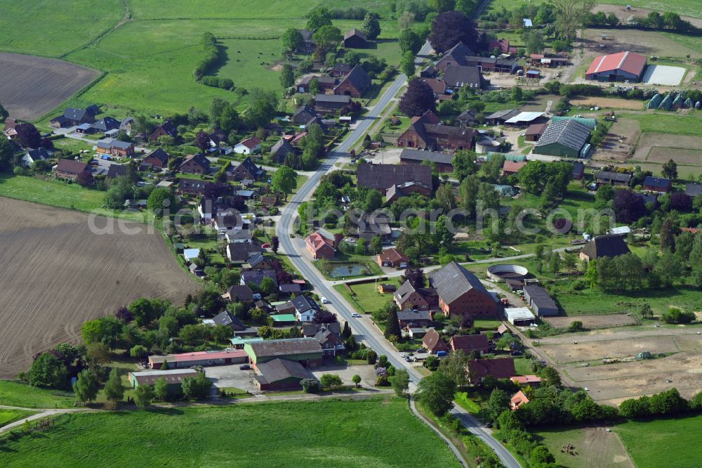 Aerial image Niendorf - Agricultural land and field boundaries surround the settlement area of the village in Niendorf in the state Schleswig-Holstein, Germany