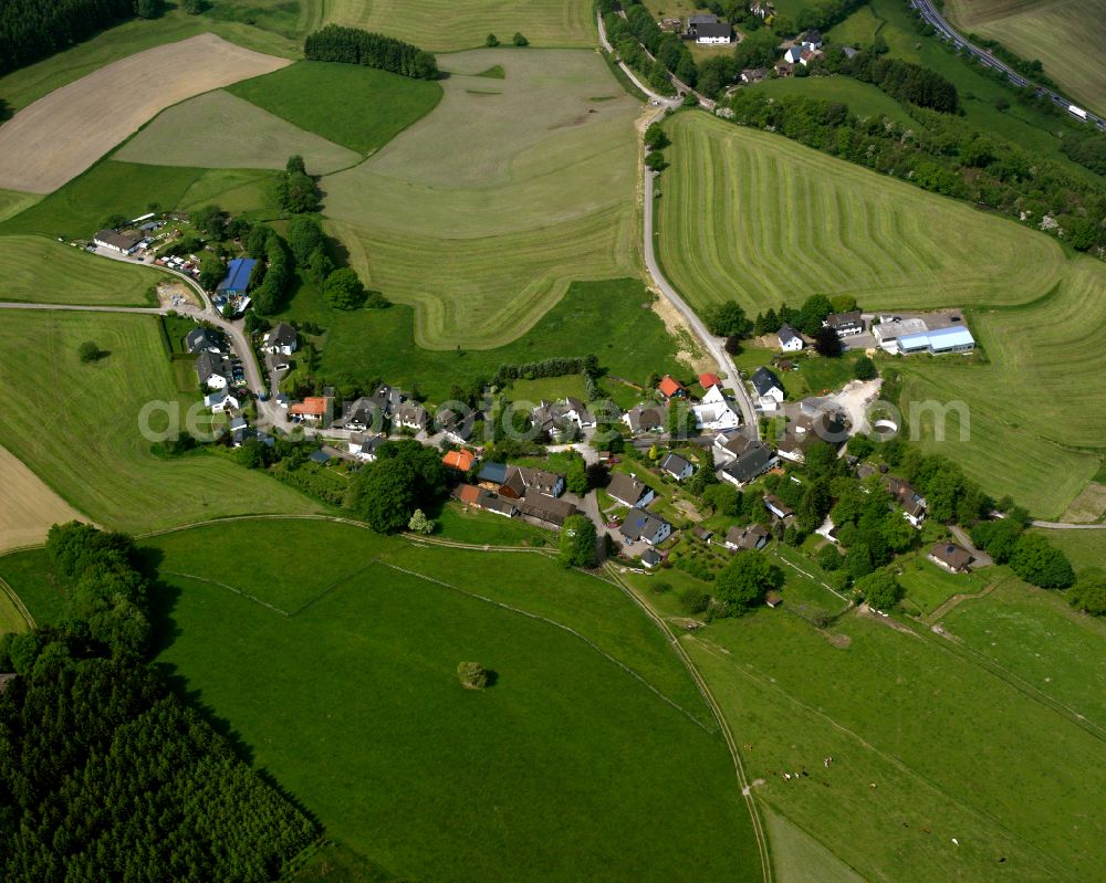 Nordhellen from the bird's eye view: Agricultural land and field boundaries surround the settlement area of the village in Nordhellen in the state North Rhine-Westphalia, Germany