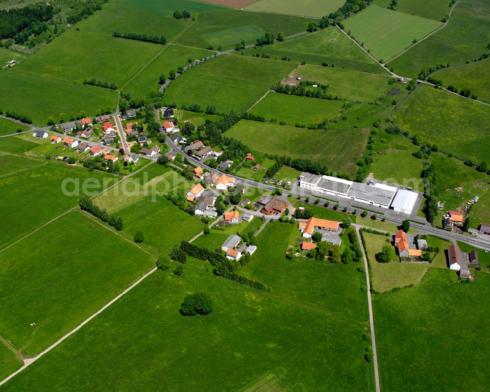 Aerial image Nösberts-Weidmoos - Agricultural land and field boundaries surround the settlement area of the village in Nösberts-Weidmoos in the state Hesse, Germany