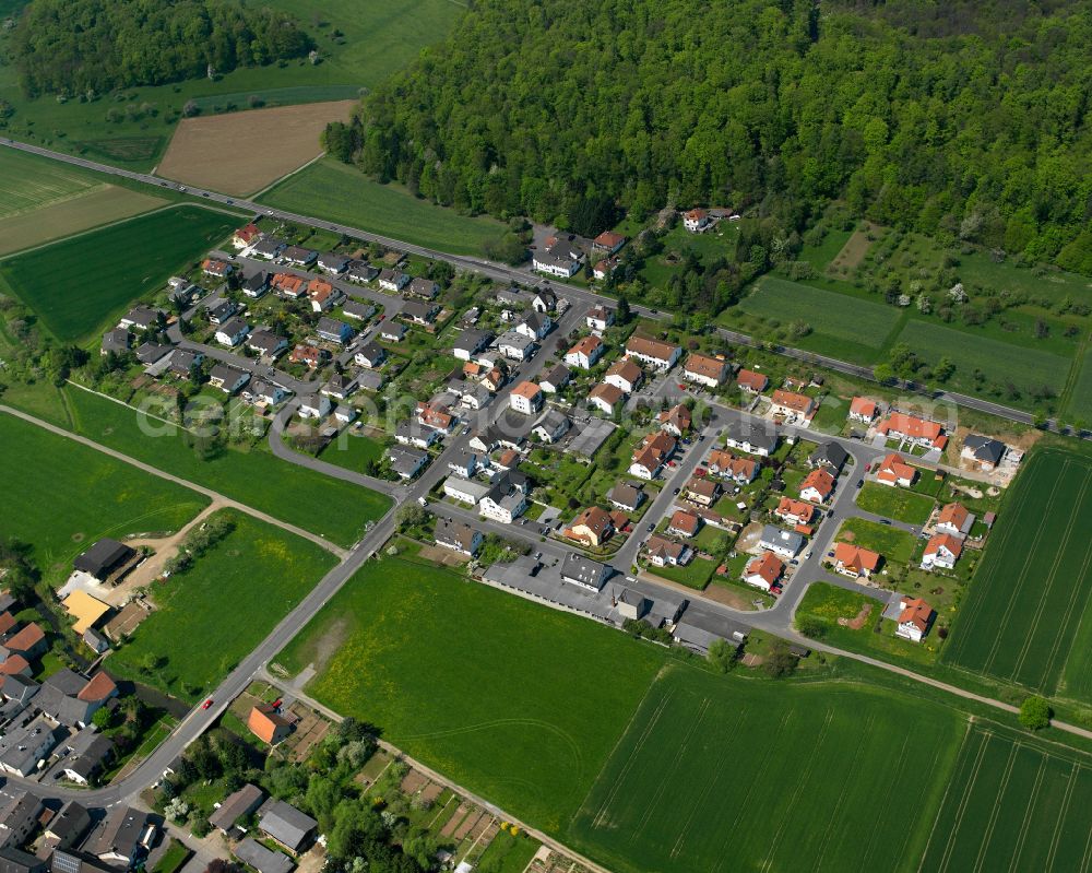 Ober-Bessingen from above - Agricultural land and field boundaries surround the settlement area of the village in Ober-Bessingen in the state Hesse, Germany