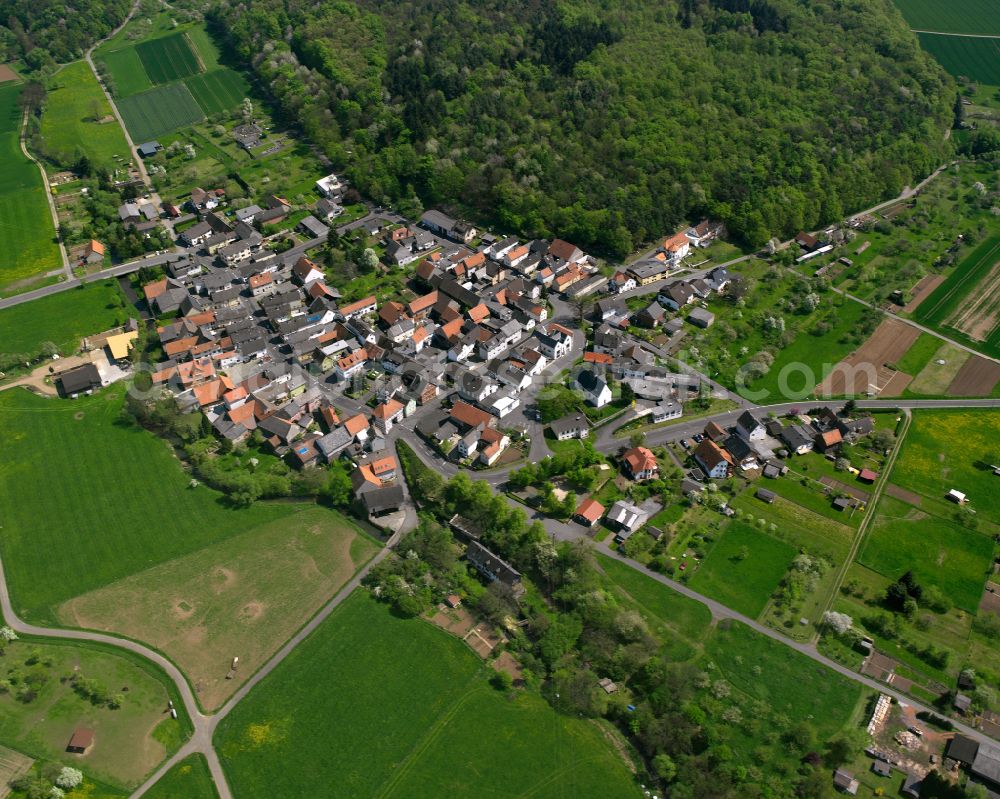 Ober-Bessingen from the bird's eye view: Agricultural land and field boundaries surround the settlement area of the village in Ober-Bessingen in the state Hesse, Germany