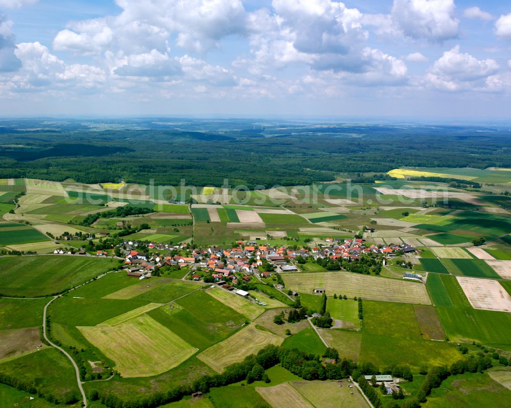 Aerial image Ober-Breidenbach - Agricultural land and field boundaries surround the settlement area of the village in Ober-Breidenbach in the state Hesse, Germany