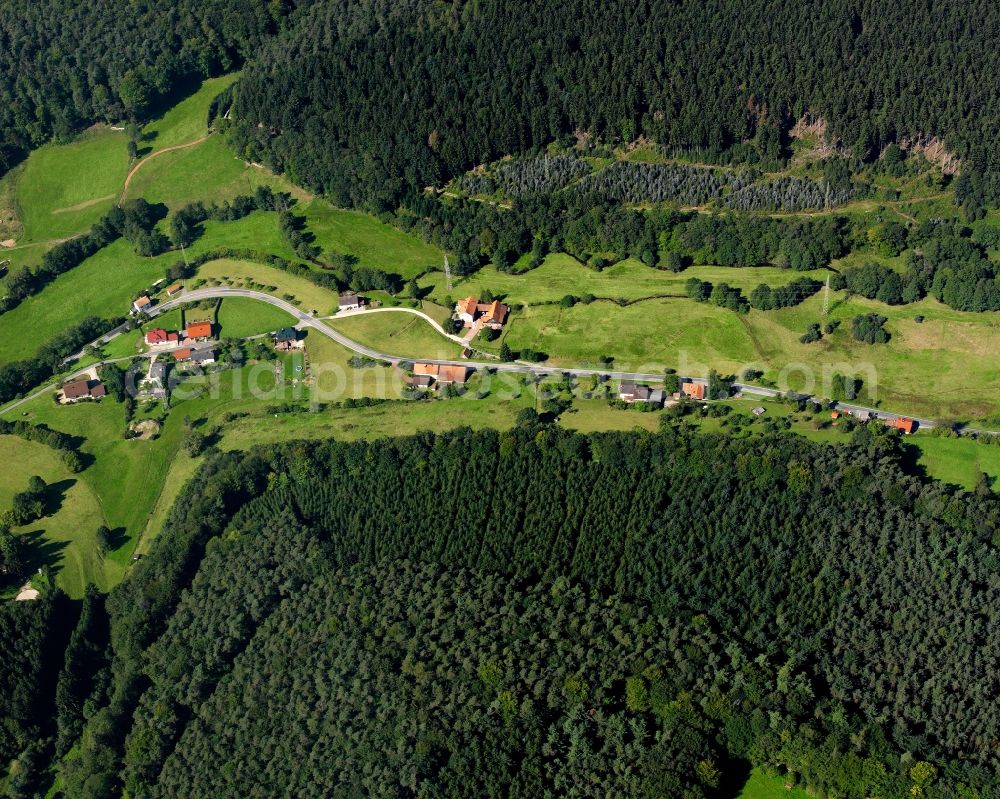 Ober-Hainbrunn from above - Agricultural land and field boundaries surround the settlement area of the village in Ober-Hainbrunn in the state Hesse, Germany