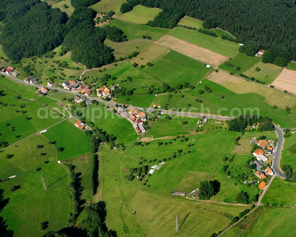 Aerial image Ober-Kainsbach - Agricultural land and field boundaries surround the settlement area of the village in Ober-Kainsbach in the state Hesse, Germany