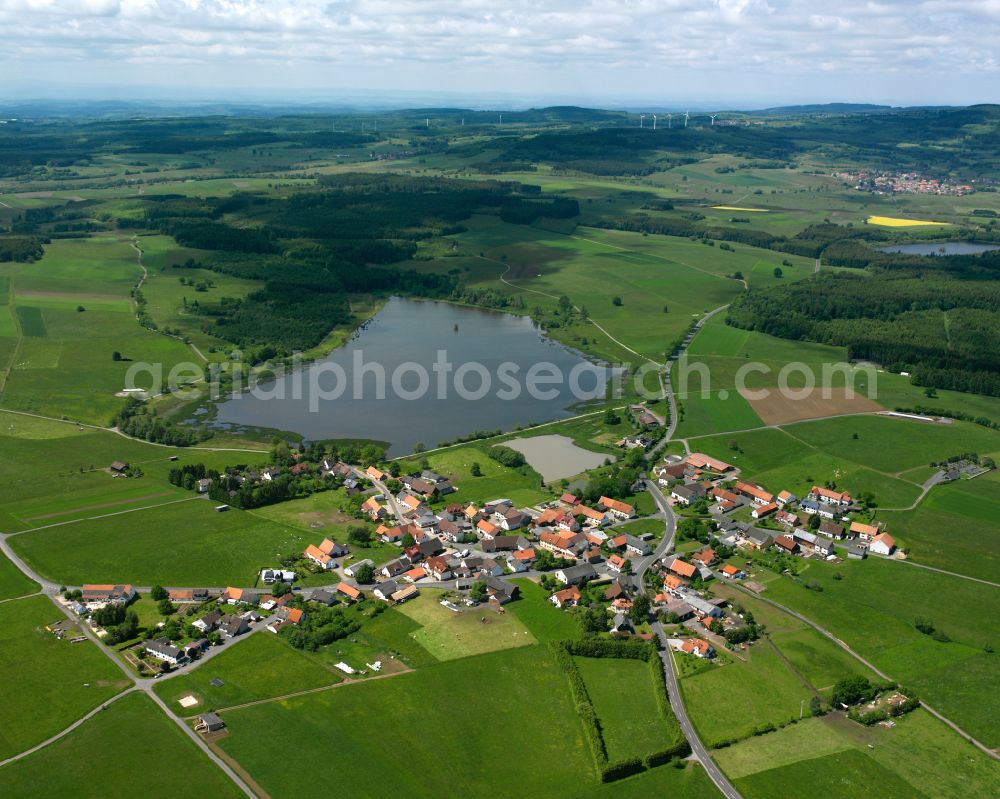 Aerial photograph Ober-Moos - Agricultural land and field boundaries surround the settlement area of the village in Ober-Moos in the state Hesse, Germany