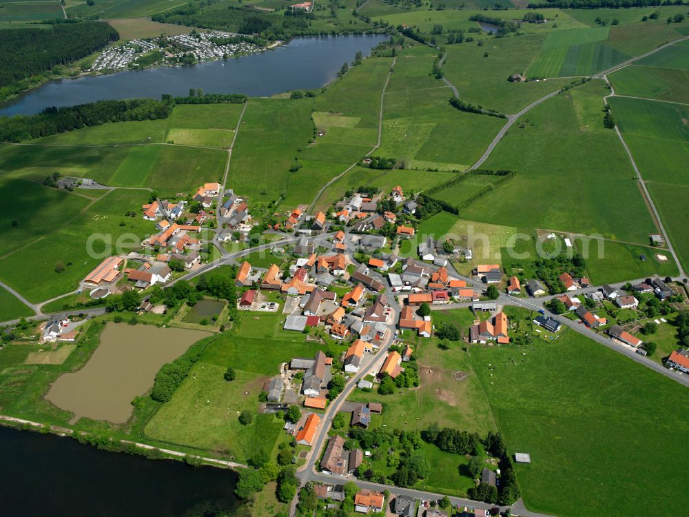 Ober-Moos from the bird's eye view: Agricultural land and field boundaries surround the settlement area of the village in Ober-Moos in the state Hesse, Germany