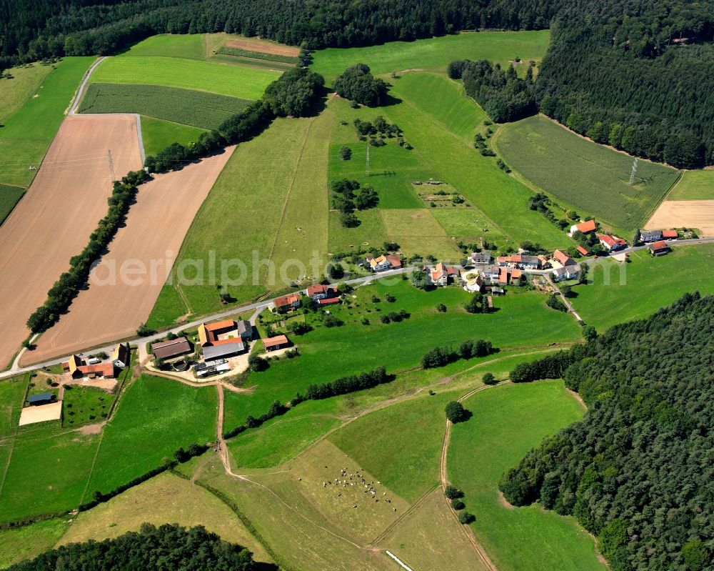 Ober-Mossau from above - Agricultural land and field boundaries surround the settlement area of the village in Ober-Mossau in the state Hesse, Germany