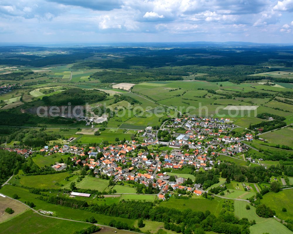 Aerial photograph Ober-Ohmen - Agricultural land and field boundaries surround the settlement area of the village in Ober-Ohmen in the state Hesse, Germany