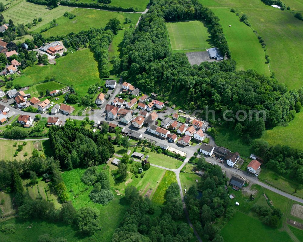 Ober-Ohmen from above - Agricultural land and field boundaries surround the settlement area of the village in Ober-Ohmen in the state Hesse, Germany