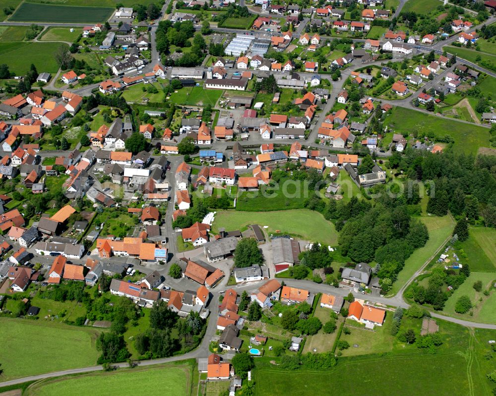 Ober-Ohmen from the bird's eye view: Agricultural land and field boundaries surround the settlement area of the village in Ober-Ohmen in the state Hesse, Germany