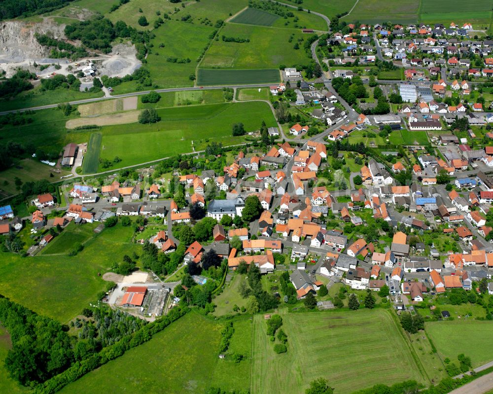 Aerial image Ober-Ohmen - Agricultural land and field boundaries surround the settlement area of the village in Ober-Ohmen in the state Hesse, Germany