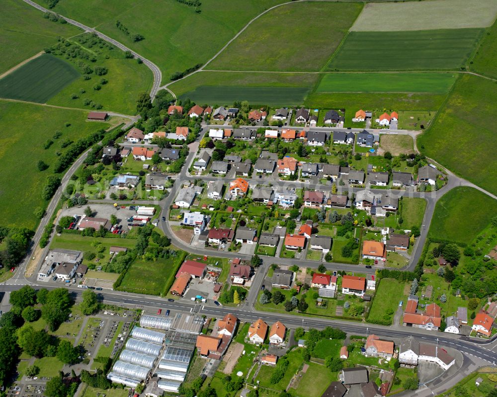 Aerial photograph Ober-Ohmen - Agricultural land and field boundaries surround the settlement area of the village in Ober-Ohmen in the state Hesse, Germany