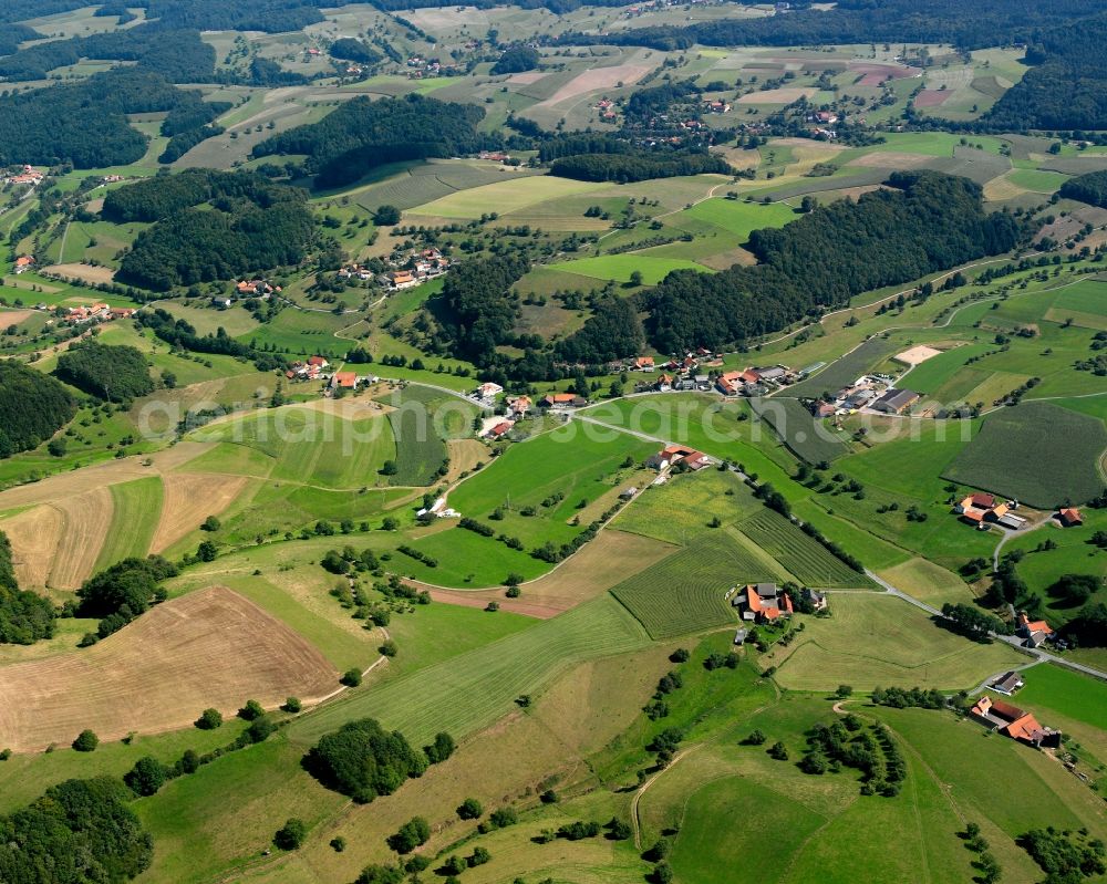 Ober-Ostern from above - Agricultural land and field boundaries surround the settlement area of the village in Ober-Ostern in the state Hesse, Germany