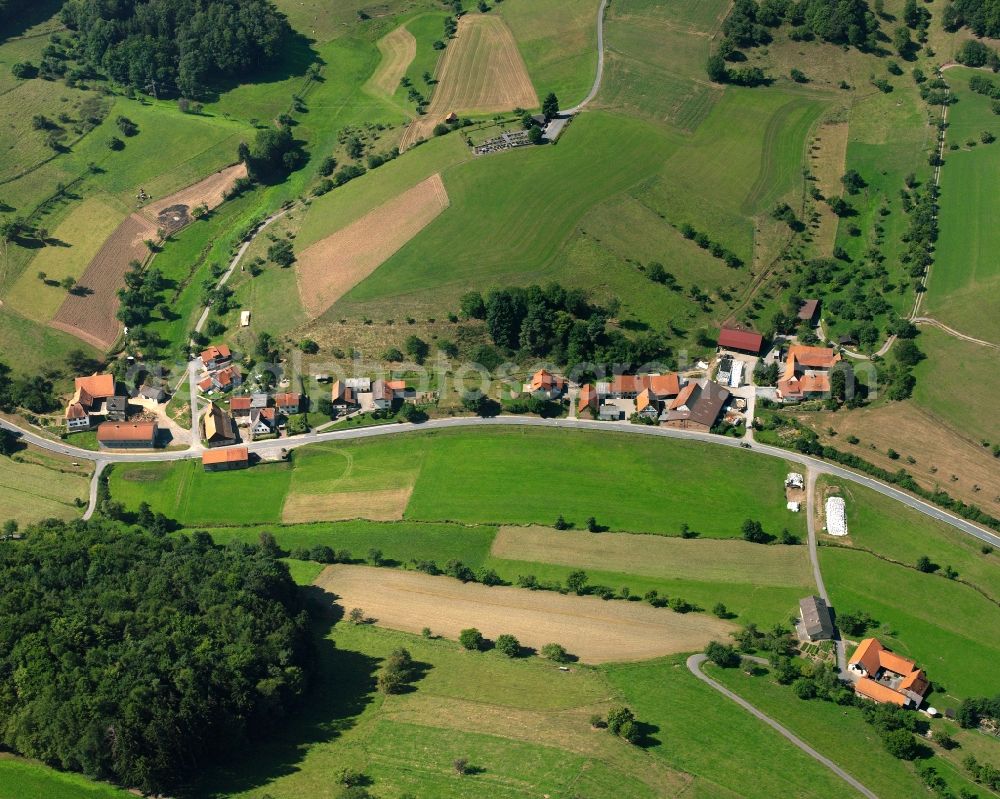 Aerial image Ober-Ostern - Agricultural land and field boundaries surround the settlement area of the village in Ober-Ostern in the state Hesse, Germany