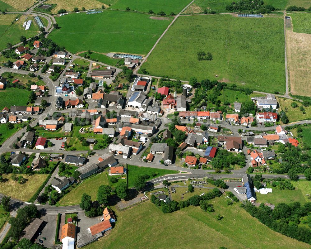 Ober-Seibertenrod from the bird's eye view: Agricultural land and field boundaries surround the settlement area of the village in Ober-Seibertenrod in the state Hesse, Germany